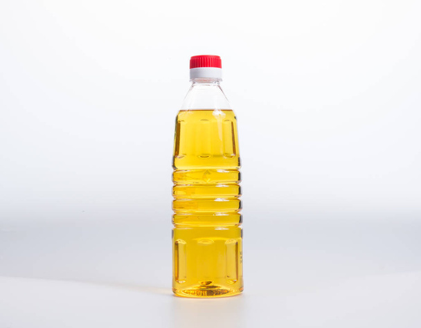 oil or oil in plastic bottle on the background. - Foto, Imagem