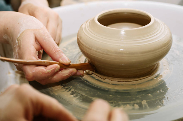 pottery. the teacher teaches the student work on the potter's wheel - Photo, Image