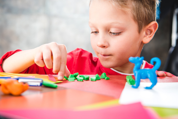 Schoolchild making toy from plasticine - Φωτογραφία, εικόνα