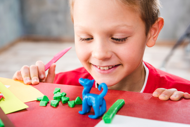 Schoolchild making toy from plasticine - Foto, Imagem
