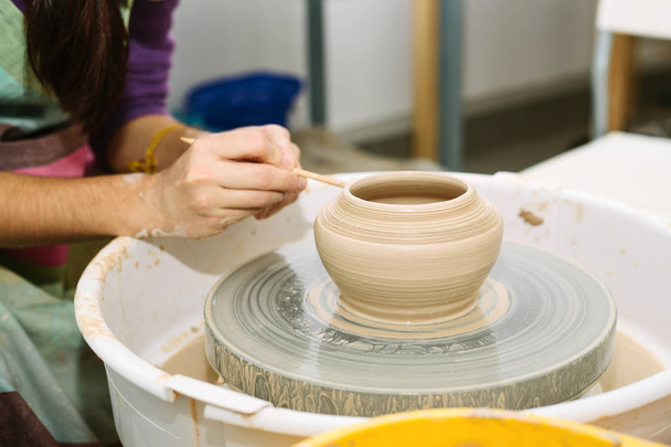 pottery. the teacher teaches the student work on the potter's wheel - 写真・画像