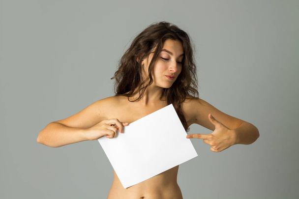 young nude girl with placard - Zdjęcie, obraz