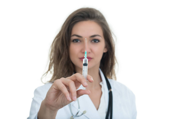 Female doctor checking a syringe - Fotoğraf, Görsel