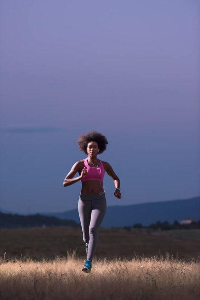 Young African american woman jogging in nature - Fotografie, Obrázek