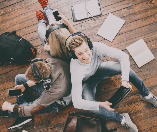 Teenage students studying on floor - Fotoğraf, Görsel