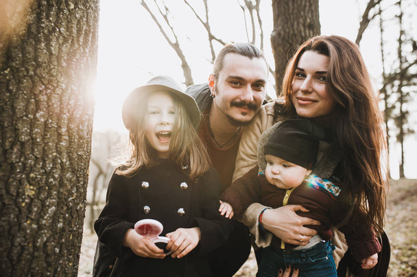 cheerful and happy family in autumn park - Foto, afbeelding
