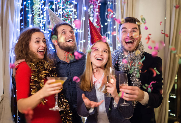 Group of friends having party on New Years Eve. - 写真・画像