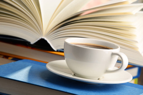 Composition with books and cup of coffee - Foto, afbeelding