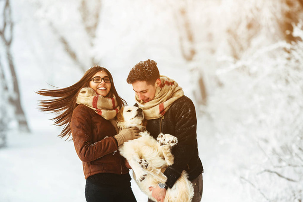Young couple having fun in winter park - Φωτογραφία, εικόνα