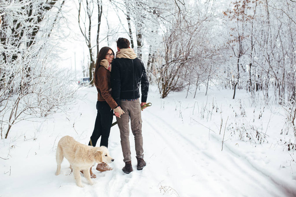 Young couple in love walking with dog - Фото, зображення