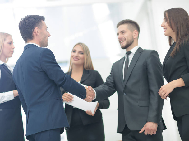 Handshake to seal a deal after a job recruitment meeting in a of - Фото, изображение