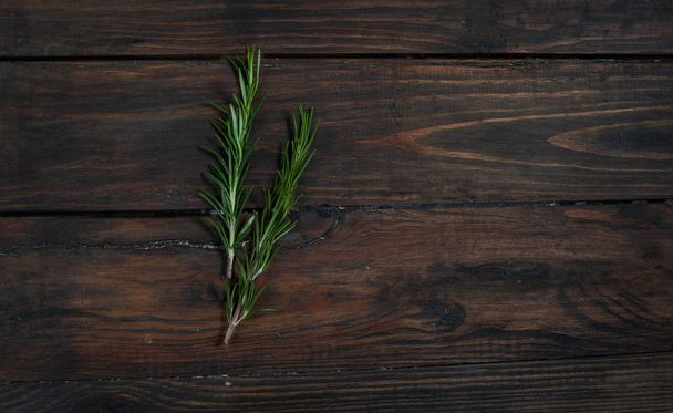 Rosemary on a wooden background - Foto, Bild