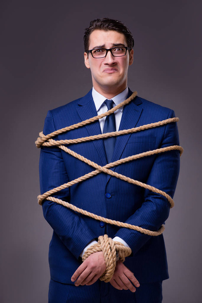 Businessman tied up with rope - Photo, image