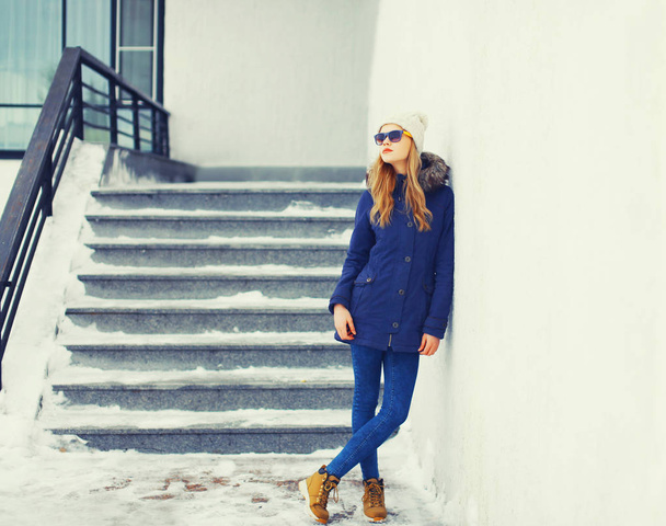 Fashion pretty blonde woman wearing jacket and hat in winter cit - Photo, image