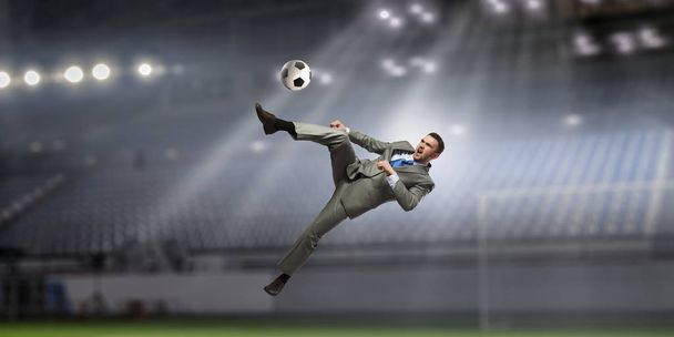 Businessman playing soccer . Mixed media - Foto, Imagem