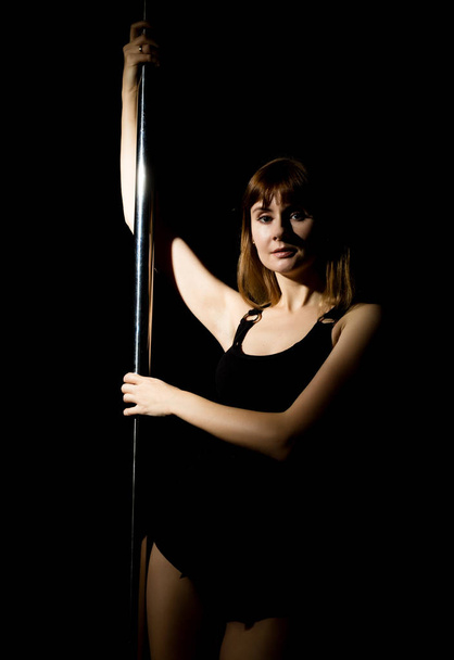 young hot woman in sexy lingerie performs sensual pole dance. Go-go dancer - Fotó, kép