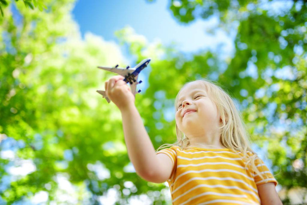 girl playing with small toy airplane  - Valokuva, kuva