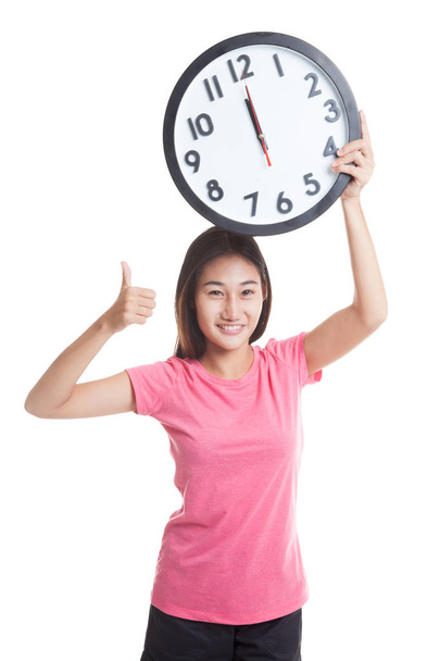 Young Asian woman thumbs up with a clock. - Valokuva, kuva