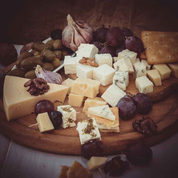 Variety of cheese with nuts and olives  - Valokuva, kuva