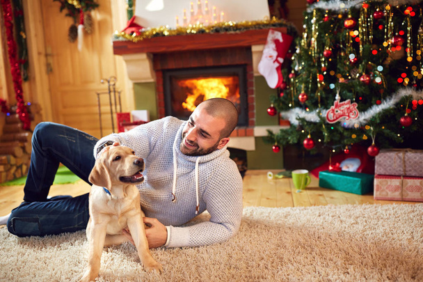 Man with dog enjoying for Christmas holiday - Фото, зображення