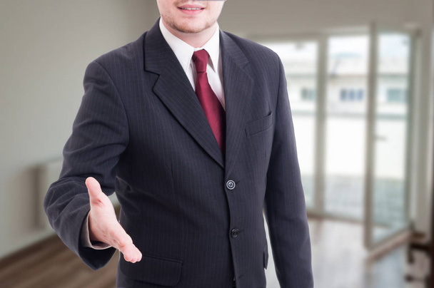 Real estate agent doing welcoming gesture - Photo, Image