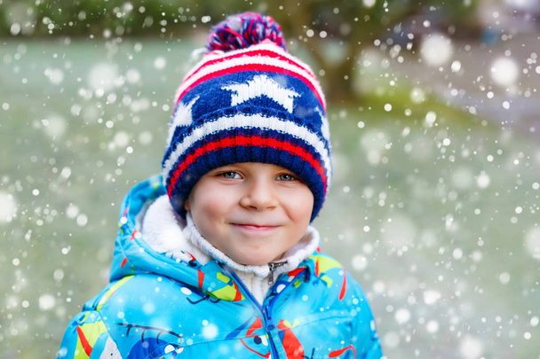 Cute little kid boy in winter clothes outdoors - Photo, Image