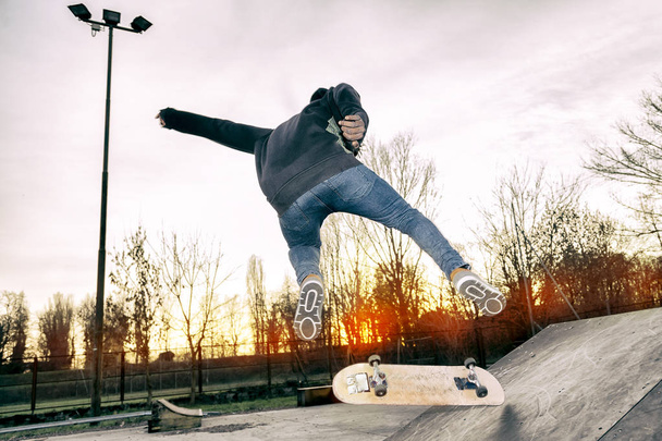 young skateboarder jumping on a ramp outdoor - Fotó, kép