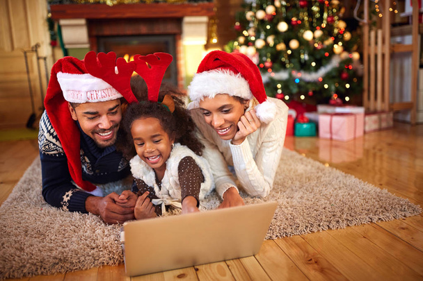 Afro American family use laptop for Christmas shopping online  - Foto, imagen