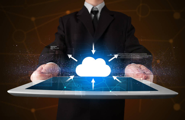 Businessman holding tablet with cloud icon - Photo, Image