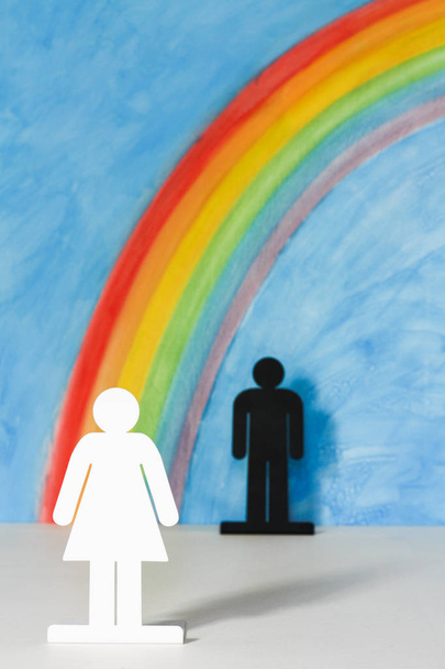 Man and women icons with a rainbow and blue sky - Photo, Image