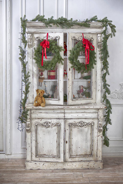 wardrobe with Christmas toys and Christmas tree garland - Fotografie, Obrázek