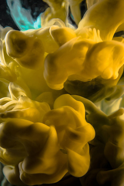 The yellow dye in the water. Abstract background. Wallpaper. Concept art - Фото, изображение