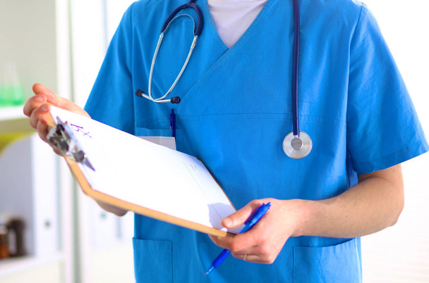 Closeup portrait of a  doctor with stethoscope holding folder - Foto, imagen