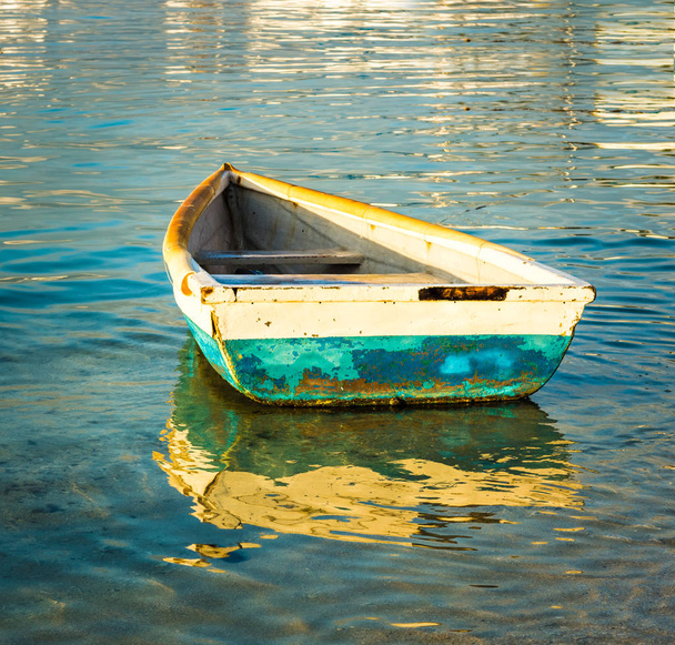 Old fishing boat at sunset - Фото, изображение
