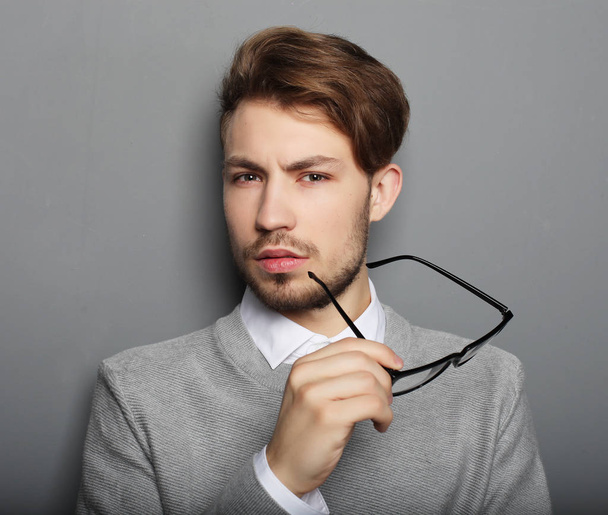 young businessman with eyeglasses, looking at the camera against - Foto, immagini