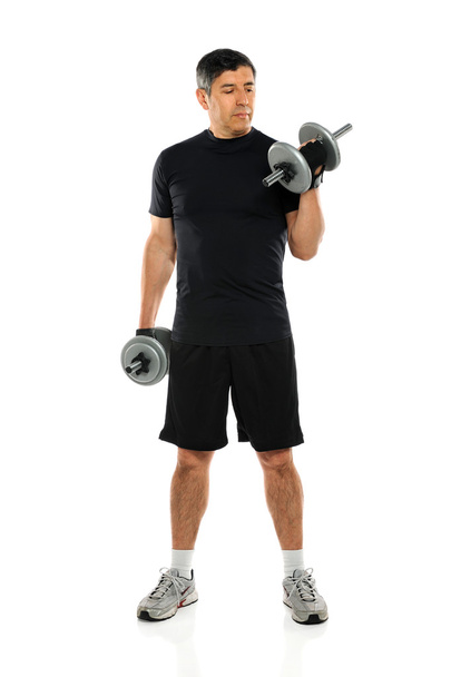 Mature Man Exercising With Dumbbells - Фото, зображення