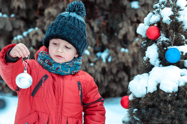 little boy decorates a Christmas tree for Christmas - Photo, Image