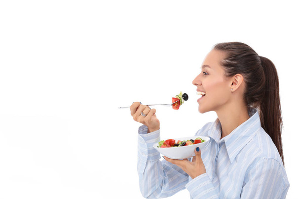 Beautiful girl eating healthy food, isolated on white background - Foto, Imagem