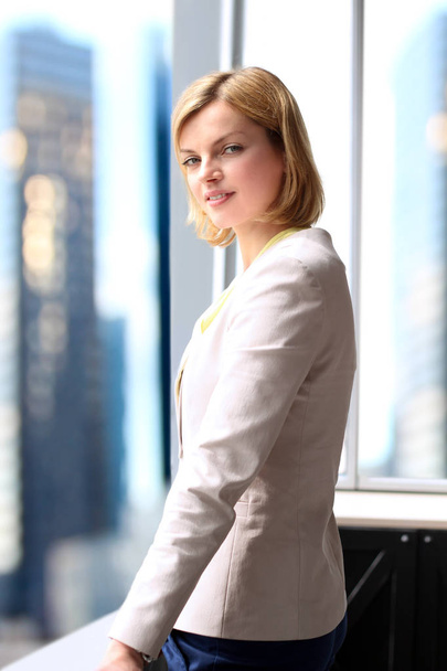 Successful businesswoman standing near with  window - Photo, Image