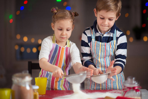 Happy  little children preparing Christmas cookies  - Valokuva, kuva