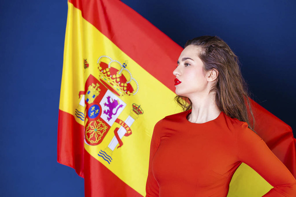 Young woman on the background of the Spanish flag - 写真・画像