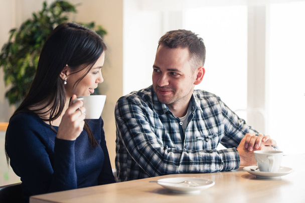 Happy couple talking at cafe, drinking tea - Fotoğraf, Görsel