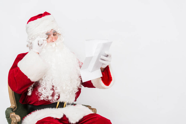 Santa Claus Reading Letter isolated over white baclground - Foto, imagen