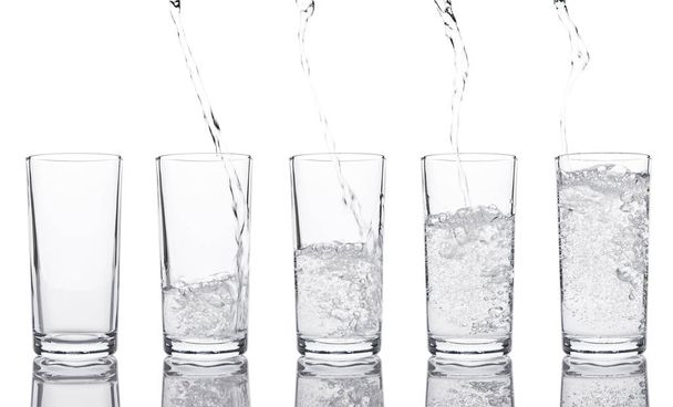 Pouring fresh healthy sparkling water to glass - Foto, afbeelding