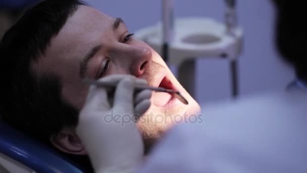 Dentist doing injection to his patient in dental clinic - Кадри, відео