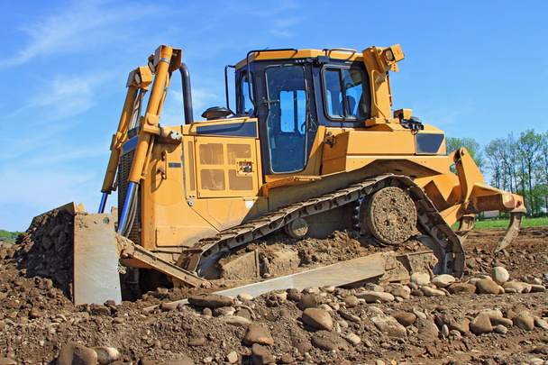 La excavadora en un sitio de construcción
 - Foto, Imagen