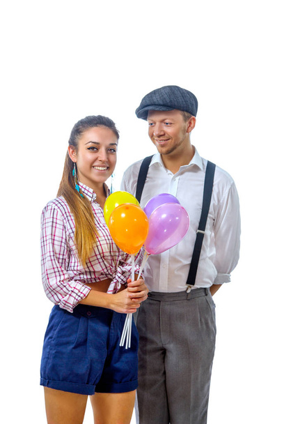 young man in a cap gave the girl balloons - 写真・画像