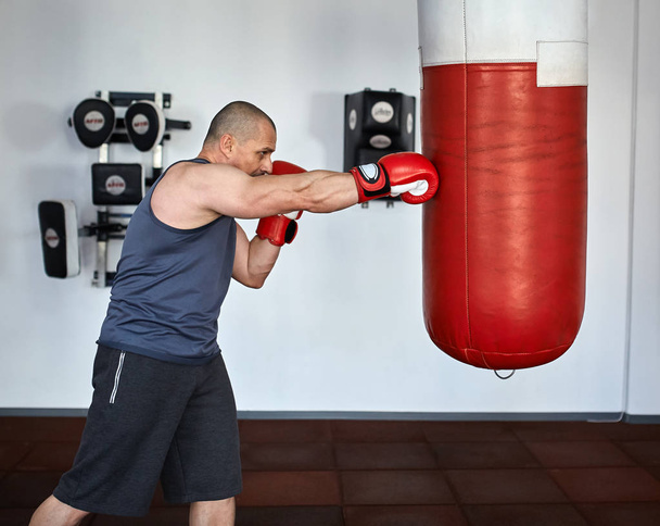 man working on punchbags - Foto, immagini
