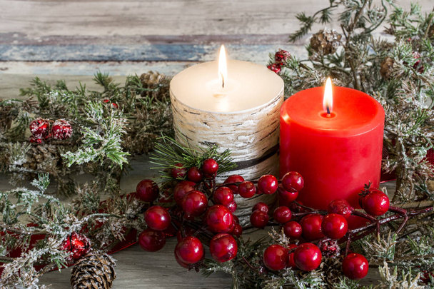 Lit candle and a stick of cranberries - Фото, изображение