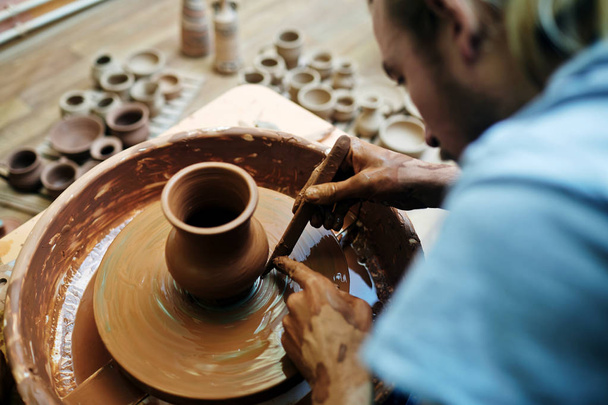 Man making clay item - Zdjęcie, obraz